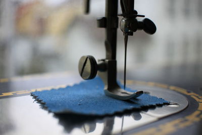 Close-up of sewing machine with cloth