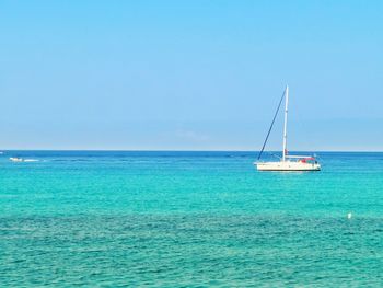 Sailboat in sea against sky