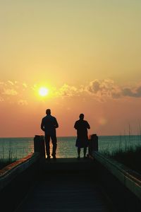 Silhouette of pier at sunset