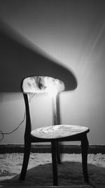 Chairs and table by illuminated lamp