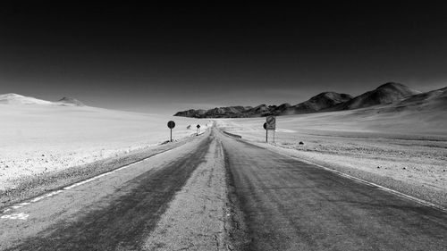 Scenic view of desert against clear sky during winter