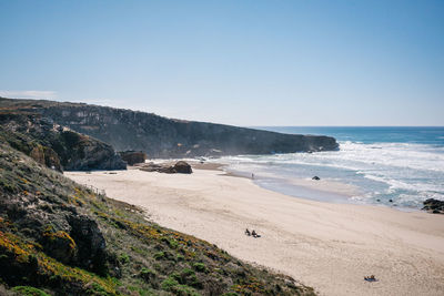 Scenic view of beach against clear sky