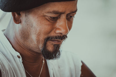 Close-up portrait of man wearing hat