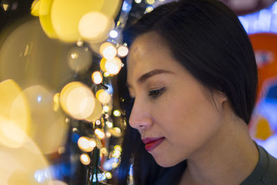 Close-up portrait of young woman looking down