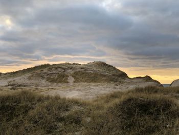 Scenic view of field against sky during sunset