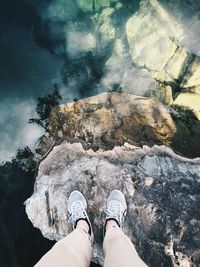 Low section of person standing on rock