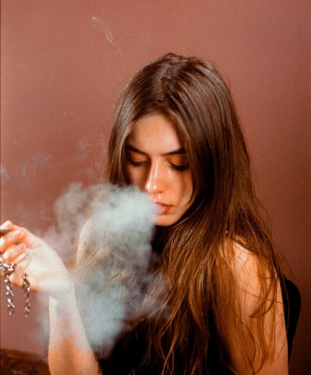 smoke, one person, smoking, human hair, women, adult, young adult, female, long hair, smoking issues, portrait, hairstyle, cigarette, headshot, indoors, holding, skin, nose, activity, bad habit, photo shoot, person, blond hair, social issues, human face, brown hair, fashion, human head, lifestyles, hand, eyes closed, looking, human mouth, waist up, blowing