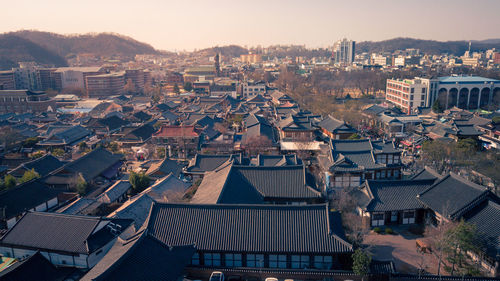 High angle view of houses in town against sky