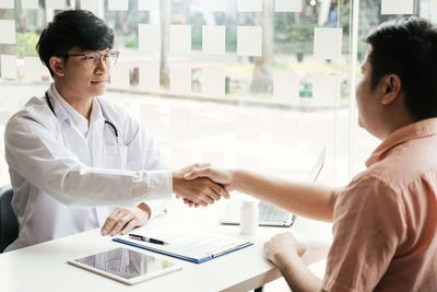 Doctor examining patient in office