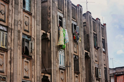 Laundry drying from a third storey window. cuban apartment block.