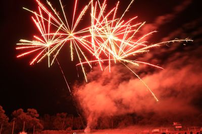 Low angle view of firework display at night