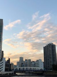 Buildings in city against sky during sunset