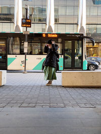 Rear view of woman on street in city