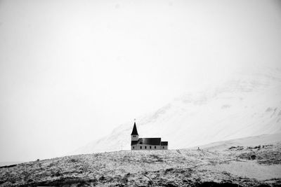 Building on mountain against clear sky