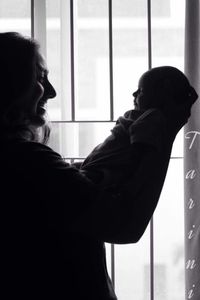 Woman looking through window