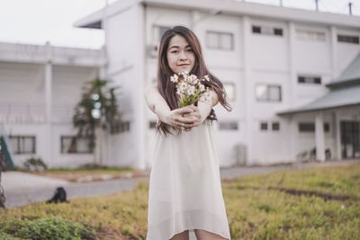 Portrait of woman standing on field