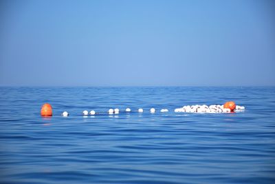 View of floating on sea against clear sky