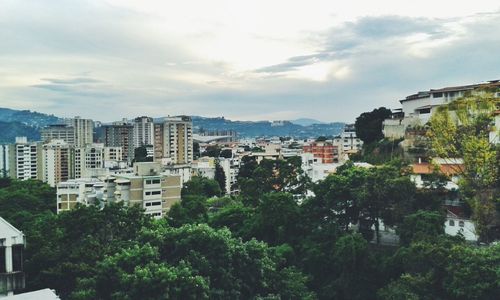 Buildings against cloudy sky