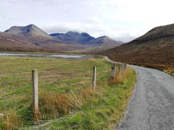 Scenic view of landscape against sky, windy road, isle of skye scotland 