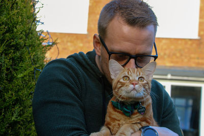 Portrait of man with cat