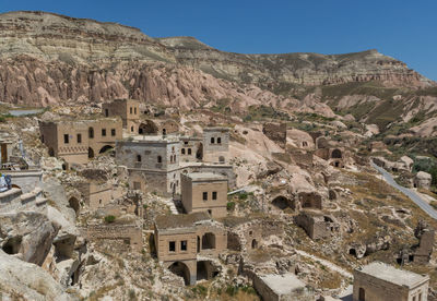 High angle view of old ruins on mountain against clear blue sky during sunny day