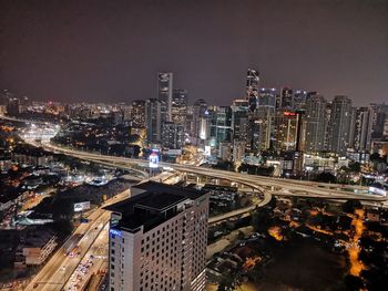 High angle view of illuminated buildings against sky at night