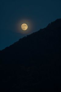 Low angle view of silhouette moon against sky at night