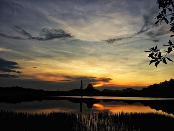 Scenic view of lake against orange sky