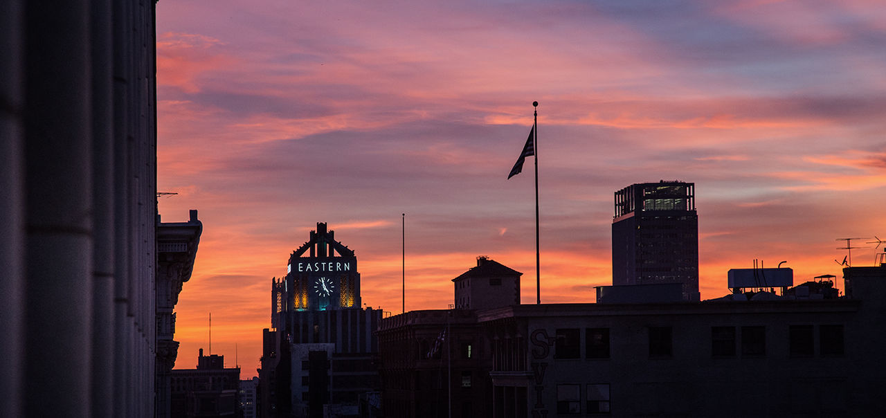 LOW ANGLE VIEW OF BUILDINGS AT SUNSET