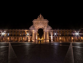 Statue in city at night