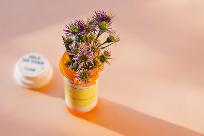 Flowers placed in the orange plastic bottle for prescribed medication. alternative medicine concept. 