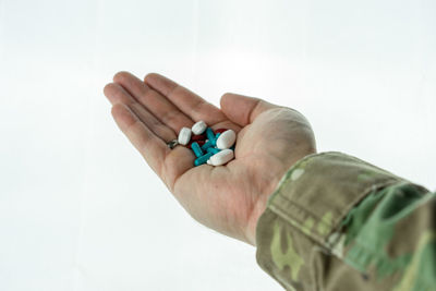 Close-up of man hand over white background