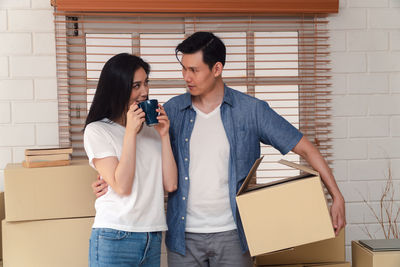 Young couple holding hands in box
