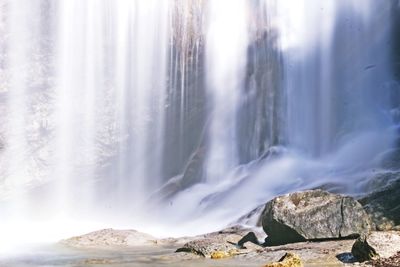 Scenic view of waterfall against sky during winter