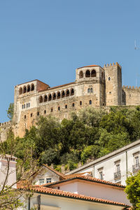 Low angle view of historical building against clear blue sky