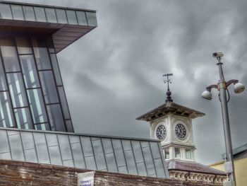 Low angle view of building against cloudy sky