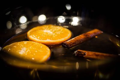 Close-up of orange slices and cinnamons