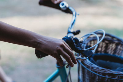 Midsection of man holding bicycle in basket
