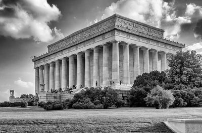 Low angle view of historical building against cloudy sky