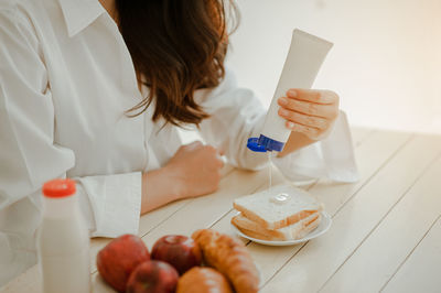 Midsection of woman preparing food on table