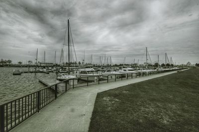 View of harbor against cloudy sky