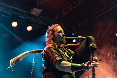 Low angle view of man with arms raised