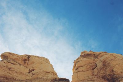 Low angle view of rock formation against sky