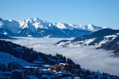 Scenic view of snowcapped mountains against blue sky