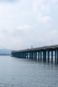 Bridge over sea against sky