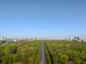 Panoramic shot of city by sea against blue sky