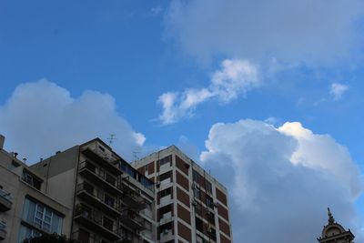 Low angle view of building against cloudy sky