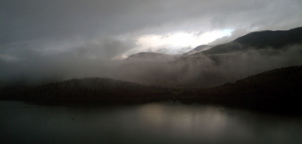 View of calm lake against mountain range