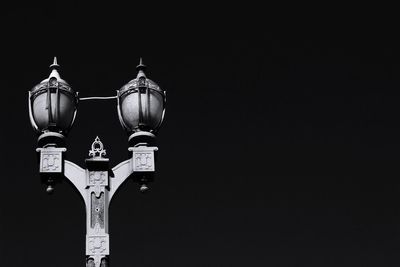Low angle view of illuminated lamp against clear sky
