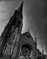 Low angle view of bell tower against sky